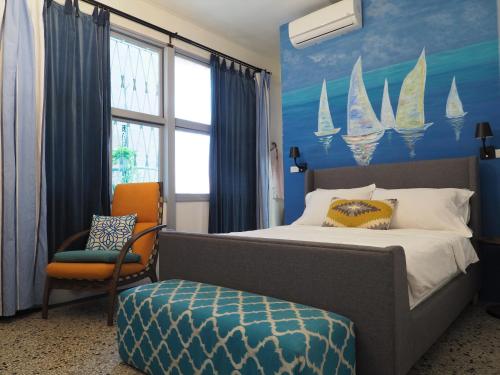 a bedroom with a bed and a chair and a window at Seamoon House in Tainan
