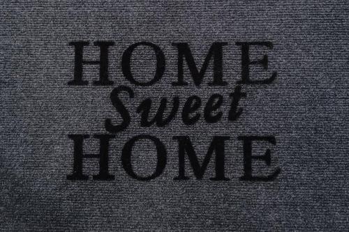 a close up of the words home sweet home written on a pillow at HOME Sweet HOME in Mytilini