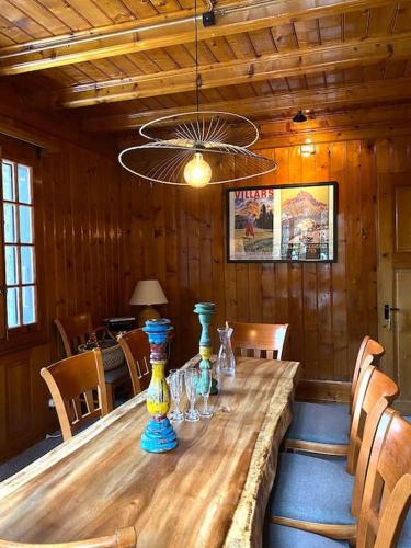 a wooden table with bottles and glasses on it at Chalet St-François in Ollon