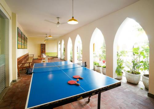 a ping pong table in a room with windows at Bloom Boutique l Signature Towers in Gurgaon