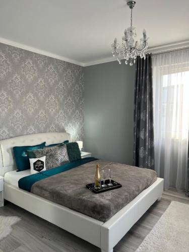 a bedroom with a large bed with a table on it at Luxurious Accommodation in Floreşti