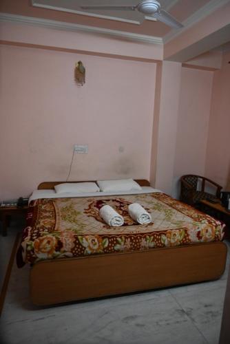 a bed in a room with two pillows on it at Hotel Atul Regency in Rāmpur