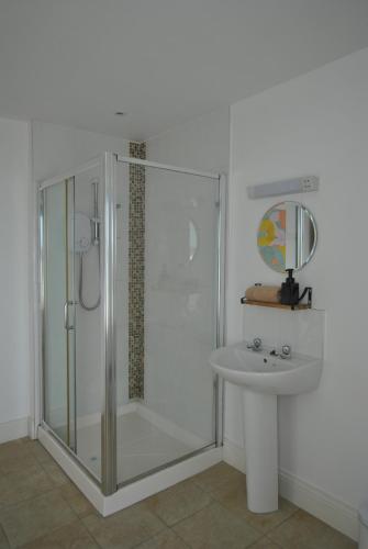 a bathroom with a shower and a sink at The Arch An Capall Dubh Dingle in Dingle