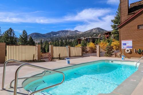 a swimming pool in a yard with a house at Aspen Creek #227 condo in Mammoth Lakes