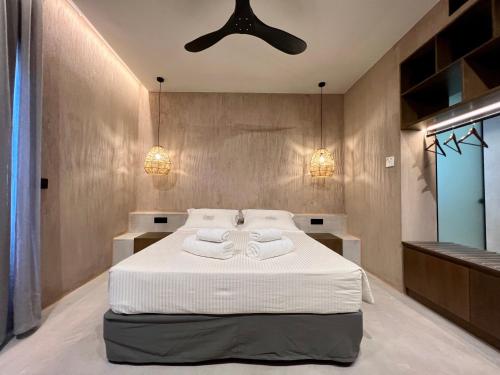 a bedroom with a bed with two towels on it at Psamathi Living & Taste in Marathi