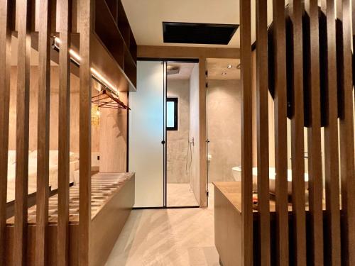 a bathroom with a shower and a glass door at Psamathi Living & Taste in Marathi