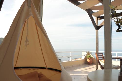 a tent on a balcony with a view of the ocean at Dream apartments limnionas in Limniónas
