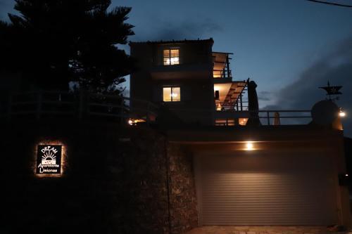 a house with a garage at night at Dream apartments limnionas in Limniónas