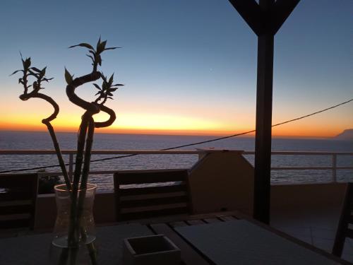a view of the sunset from a table on a cruise ship at Dream apartments limnionas in Limniónas