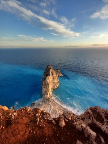an island in the ocean with a rock in the water at Pansion Limni in Keri