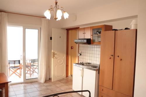 a kitchen with a white refrigerator and a window at Dream apartments limnionas in Limniónas