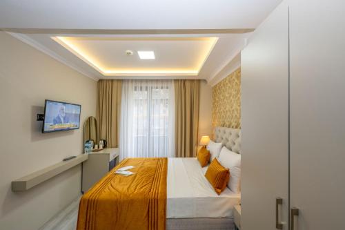 a hotel room with a large bed and a window at SKYSTAR DELUXE HOTEL in Istanbul