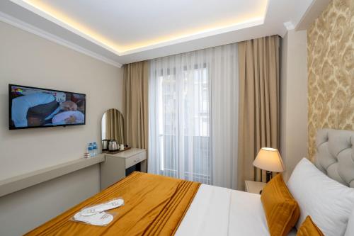 a hotel room with a bed and a window at SKYSTAR DELUXE HOTEL in Istanbul