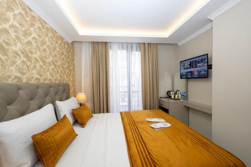 a hotel room with a large bed and a window at SKYSTAR DELUXE HOTEL in Istanbul