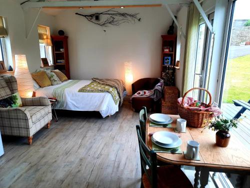 a bedroom with a bed and a table with a dining room at The Wood Cottage in Scarborough
