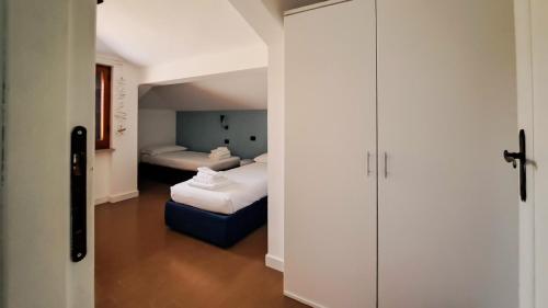 een kamer met een slaapkamer met 2 bedden en een kast bij Attico sul mare in Montesilvano
