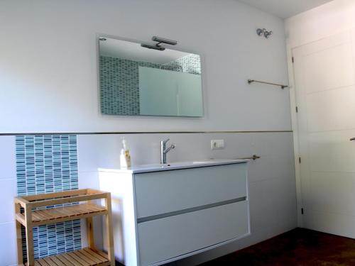 a bathroom with a sink and a mirror on the wall at Setè cel in Begur