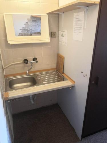 a bathroom with a sink in a room at Hostel Pestalozza in Špindlerův Mlýn