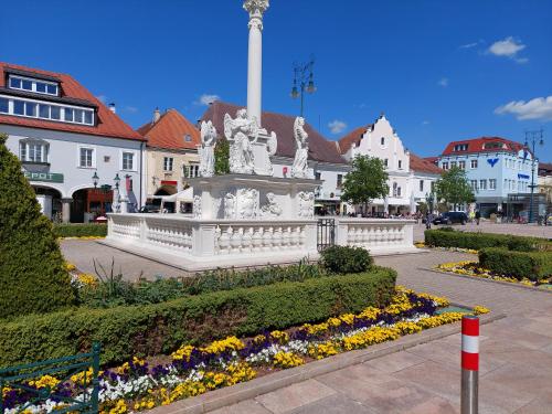 a white monument in the middle of a town at Pension Welserhof in Wilfersdorf
