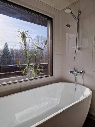 a white bath tub in a bathroom with a window at Botnia Hotel & Restaurant in Kruunupyy