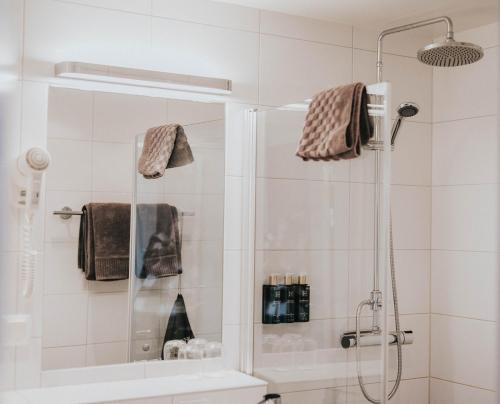 a bathroom with a shower and a sink at Clarion Collection Hotel Majoren in Skövde