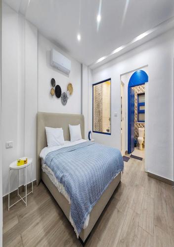a bedroom with a bed and a blue door at Lara Family Resorts in Mukāwir