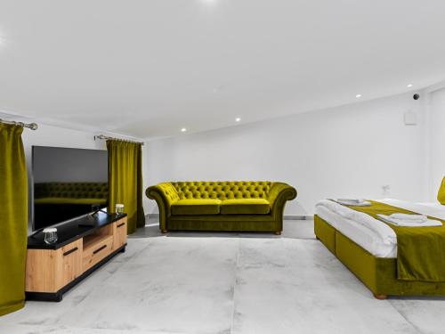 a living room with a yellow couch and a television at Transylvania House in Arieşeni