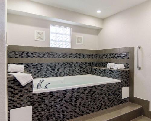 a bath tub in a bathroom with a window at Econo Lodge Russellville I-40 in Russellville