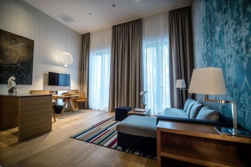 a hotel room with a bed and a desk at The Wellem, in The Unbound Collection by Hyatt in Düsseldorf