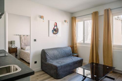 - un salon avec une chaise et un canapé dans l'établissement Le Saint Amans, à Rodez