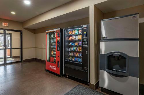 a cocacola soda machine next to a drink cooler at Comfort Inn Collinsville near St Louis in Collinsville