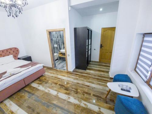 a bedroom with a bed and a table and a chair at Transylvania House in Arieşeni