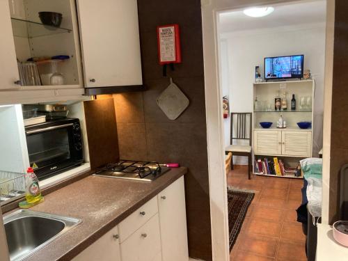 uma pequena cozinha com um lavatório e um fogão em Special Suite Bairro Alto em Lisboa