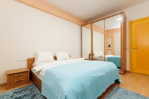 a bedroom with a large bed and a mirror at Elite Rent Anestiade in Chişinău