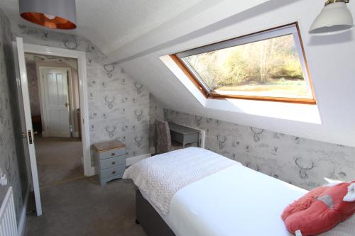 a small bedroom with a bed and a window at Fern Howe Guest House in Keswick