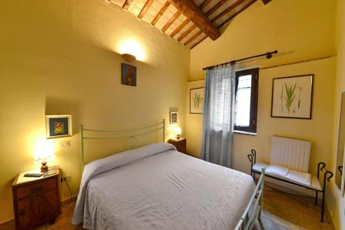 a bedroom with a bed and a window at Agriturismo Sasso Rosso in Capodacqua