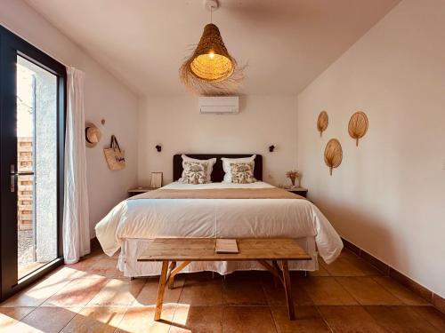 a bedroom with a bed and a large window at 4 Saisons en Provence in Saint-Paul-en-Forêt