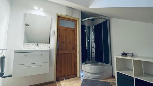 a bathroom with a shower and a toilet and a sink at Apartament Pod Kasztanami - ZIELONY in Ińsko