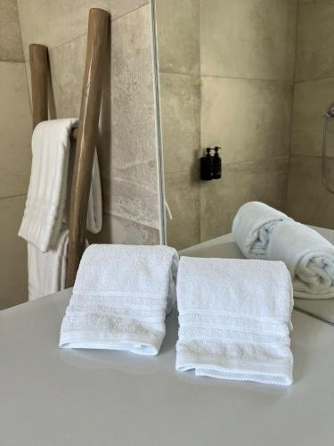 two towels sitting on a table in a bathroom at À Espera - Turismo Rural,Melides in Melides