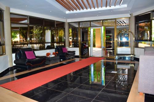 a lobby with black chairs and a red carpet at Ufanisi Resort - Kisii in Kisii
