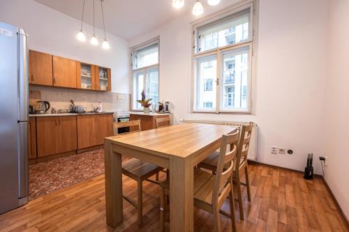 プラハにあるApartment Lublanska 48の木製テーブルと椅子付きの広いキッチン