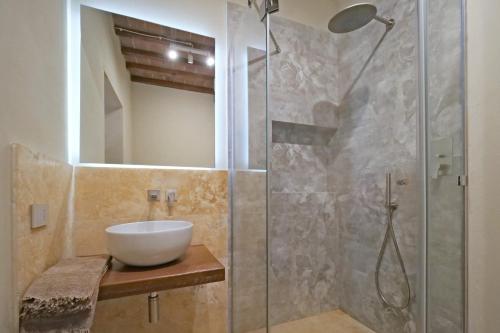 a bathroom with a sink and a shower at Delcorto Suites in Montepulciano