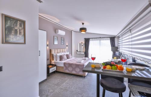 ein Zimmer mit einem Bett und einem Tisch mit Obst darauf in der Unterkunft White House Apart in Kaş