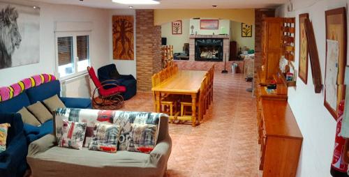 a living room with a couch and a table at EL PINAR DE BARDENA in Carcastillo