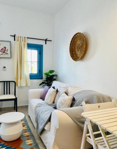 a living room with a white couch and a table at Jakaranda Unique Apart in Bodrum City