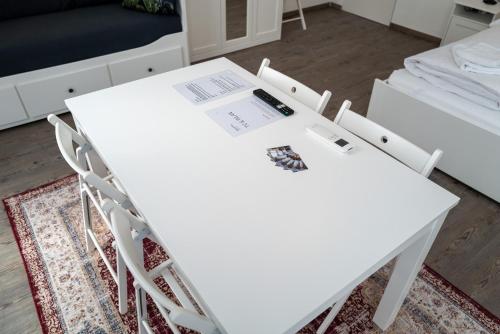 - une table et des chaises blanches dans la chambre dans l'établissement Vienna4you 14 you are welcome, à Vienne