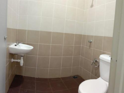 a bathroom with a toilet and a sink at MAS'homestay perlis in Kangar