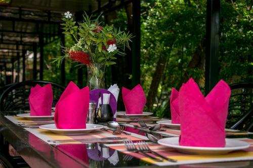 a table with pink napkins on top of it at Ufanisi Resort - Kisii in Kisii