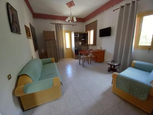 a living room with two couches and a table at Agnanti house in Symi