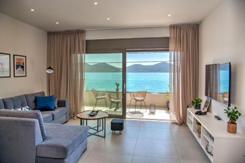 a living room with a view of the ocean at Blue Cove Infinity in Elounda